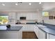 Bright kitchen featuring white cabinets, stainless appliances, and sleek countertops at 2261 Evening Lights St, Henderson, NV 89052
