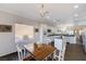 Open concept kitchen and dining area with white cabinetry and island at 2261 Evening Lights St, Henderson, NV 89052