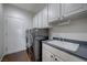 Functional laundry area with a large sink, full-sized washer/dryer and ample cabinet space at 2261 Evening Lights St, Henderson, NV 89052