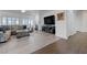 Open living room with fireplace, large sofa, and hardwood floors at 2261 Evening Lights St, Henderson, NV 89052