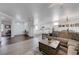 Comfortable living room with an open layout to the kitchen, featuring light wood floors and neutral colors at 2261 Evening Lights St, Henderson, NV 89052