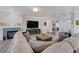 Bright living room with fireplace, entertainment center, and large sectional sofa at 2261 Evening Lights St, Henderson, NV 89052