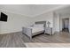 Spacious main bedroom with wood floors and neutral color scheme at 2261 Evening Lights St, Henderson, NV 89052