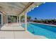 Inviting backyard pool surrounded by a covered patio, perfect for enjoying summer days and entertaining friends and Gathering at 2261 Evening Lights St, Henderson, NV 89052