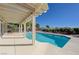Inviting backyard pool with a covered patio, ideal for outdoor entertaining and relaxation on a sunny day at 2261 Evening Lights St, Henderson, NV 89052