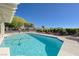 Sparkling backyard pool with concrete surround, providing a refreshing oasis for leisure and recreation on a clear day at 2261 Evening Lights St, Henderson, NV 89052