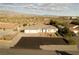 Aerial view featuring a well-maintained home with a three-car garage and desert surroundings at 2261 Pampa Ave, Pahrump, NV 89048