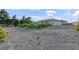 The backyard has gravel, minimal vegetation, and a view of the house at 2261 Pampa Ave, Pahrump, NV 89048
