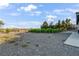 Backyard features gravel, vegetation, and partial shade from trees at 2261 Pampa Ave, Pahrump, NV 89048