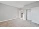 Bright bedroom with neutral carpet, closet, and view to the kitchen at 2261 Pampa Ave, Pahrump, NV 89048