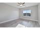 Bedroom with light gray laminate wood floors and a window overlooking neighborhood at 2261 Pampa Ave, Pahrump, NV 89048