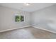 Bedroom with neutral carpet and a window overlooking treed landscape at 2261 Pampa Ave, Pahrump, NV 89048