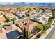Residential aerial showcases the terracotta tile roof, landscaping, and mountain views of this desert community home at 2365 Black River Falls Dr, Henderson, NV 89044
