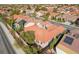 Aerial view of the house with a terra cotta roof in a neighborhood with mature trees and swimming pools at 2365 Black River Falls Dr, Henderson, NV 89044