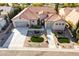 Aerial shot of desert home with a terracotta roof, meticulously landscaped yard, and a long driveway at 2365 Black River Falls Dr, Henderson, NV 89044