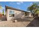 Spacious backyard features desert landscaping and a view of the home's exterior at 2365 Black River Falls Dr, Henderson, NV 89044