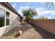 Backyard features desert landscaping, a mature tree, and a view of the home at 2365 Black River Falls Dr, Henderson, NV 89044