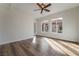 Sun-filled bedroom featuring wood-look floors, ceiling fan, and bright windows at 2365 Black River Falls Dr, Henderson, NV 89044