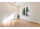 Bright bedroom with tile flooring, a large window, and a small plant, perfect for a home office or guest room at 2365 Black River Falls Dr, Henderson, NV 89044