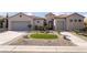 Beautiful single-story home with a well-manicured lawn, desert landscaping and charming architectural details at 2365 Black River Falls Dr, Henderson, NV 89044