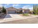 Charming single-story home featuring a well-manicured front yard, spacious driveway, and a two-car garage at 2365 Black River Falls Dr, Henderson, NV 89044