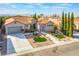 Charming single-story home featuring desert landscaping, a tile roof, and dual garages at 2365 Black River Falls Dr, Henderson, NV 89044