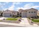 Charming single-story home showcasing a desert landscape, a neutral color palette, and a terracotta tile roof at 2365 Black River Falls Dr, Henderson, NV 89044