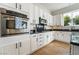 Well-lit kitchen with stainless steel appliances, black countertops, and white cabinetry at 2365 Black River Falls Dr, Henderson, NV 89044