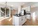 Open concept kitchen features a central island with black granite counters and tile flooring at 2365 Black River Falls Dr, Henderson, NV 89044
