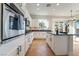 A kitchen with stainless steel appliances, white cabinets, and black countertops at 2365 Black River Falls Dr, Henderson, NV 89044
