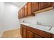 Well-equipped laundry room boasts ample cabinet space and a utility sink at 2365 Black River Falls Dr, Henderson, NV 89044