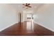 Cozy living room with hardwood floors, ceiling fan, and access to a second room with lots of sunlight at 2365 Black River Falls Dr, Henderson, NV 89044