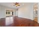 Spacious bedroom with hardwood floors, ceiling fan, and access to a bathroom, perfect for relaxation at 2365 Black River Falls Dr, Henderson, NV 89044