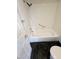 White tiled bathroom with hand held shower head and white tub at 2761 Lodestone Dr # 63, Las Vegas, NV 89117