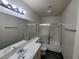 Bathroom with a double sink vanity, shower, and tiled floor is move-in ready at 2761 Lodestone Dr # 63, Las Vegas, NV 89117