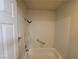 Bright bathroom with white tiled shower/tub combo and grab bars at 2761 Lodestone Dr # 63, Las Vegas, NV 89117