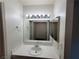 Bathroom featuring a mirror and vanity with bright lighting and tile countertops at 2761 Lodestone Dr # 63, Las Vegas, NV 89117