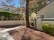 A sidewalk leading to an entry featuring well-maintained landscaping, trees and mature shrubs at 2761 Lodestone Dr # 63, Las Vegas, NV 89117