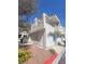 Exterior view of a townhome with a garage and well maintained landscaping at 2761 Lodestone Dr # 63, Las Vegas, NV 89117