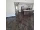 Open kitchen with stainless appliances, dark wood flooring and tiled breakfast bar at 2761 Lodestone Dr # 63, Las Vegas, NV 89117
