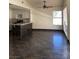 Open-concept floor plan with bar, kitchen, and dark tile floors at 2761 Lodestone Dr # 63, Las Vegas, NV 89117