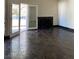 Bright living room showcasing a fireplace, French doors and dark tile flooring at 2761 Lodestone Dr # 63, Las Vegas, NV 89117