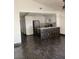 Open-concept area with a view of the kitchen, featuring dark tile floors and abundant natural light at 2761 Lodestone Dr # 63, Las Vegas, NV 89117