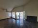 Living room with vaulted ceiling, ceiling fan, and a fireplace at 2761 Lodestone Dr # 63, Las Vegas, NV 89117