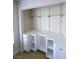 Customized built-in office with cabinets, shelving, and laminate floors at 2761 Lodestone Dr # 63, Las Vegas, NV 89117