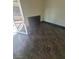 Room featuring dark tile flooring and an access door to a balcony at 2761 Lodestone Dr # 63, Las Vegas, NV 89117