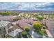 Aerial view of a home showcasing its backyard, neighboring houses, and mountain views at 2785 Rosenhearty Dr, Henderson, NV 89044