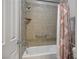 Tiled bathroom features a shower-tub combo with grab bar and curtain at 2785 Rosenhearty Dr, Henderson, NV 89044