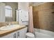 Bright bathroom featuring vanity, commode and tiled tub at 2785 Rosenhearty Dr, Henderson, NV 89044