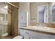 Well-lit bathroom featuring a tiled shower, white vanity, and ample storage space at 2785 Rosenhearty Dr, Henderson, NV 89044